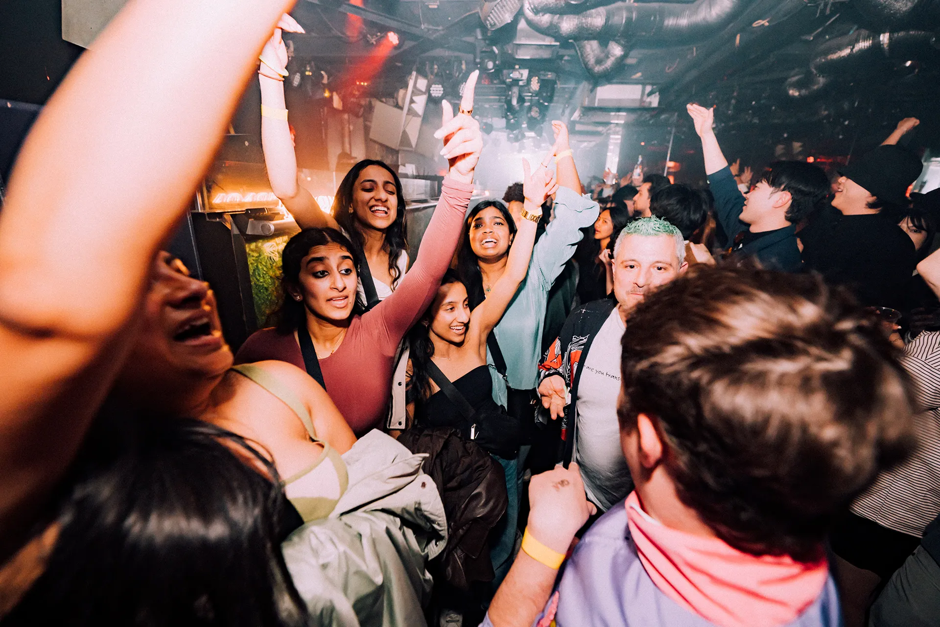 Guests with hands up enjoying the night at GALA RESORT